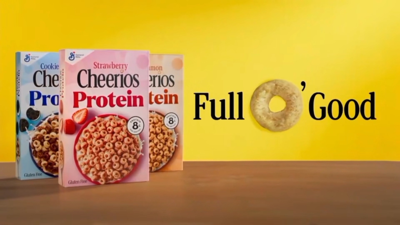 Cheerios Protein cereal boxes sit beside a Full O’ Good slogan on a yellow backdrop.