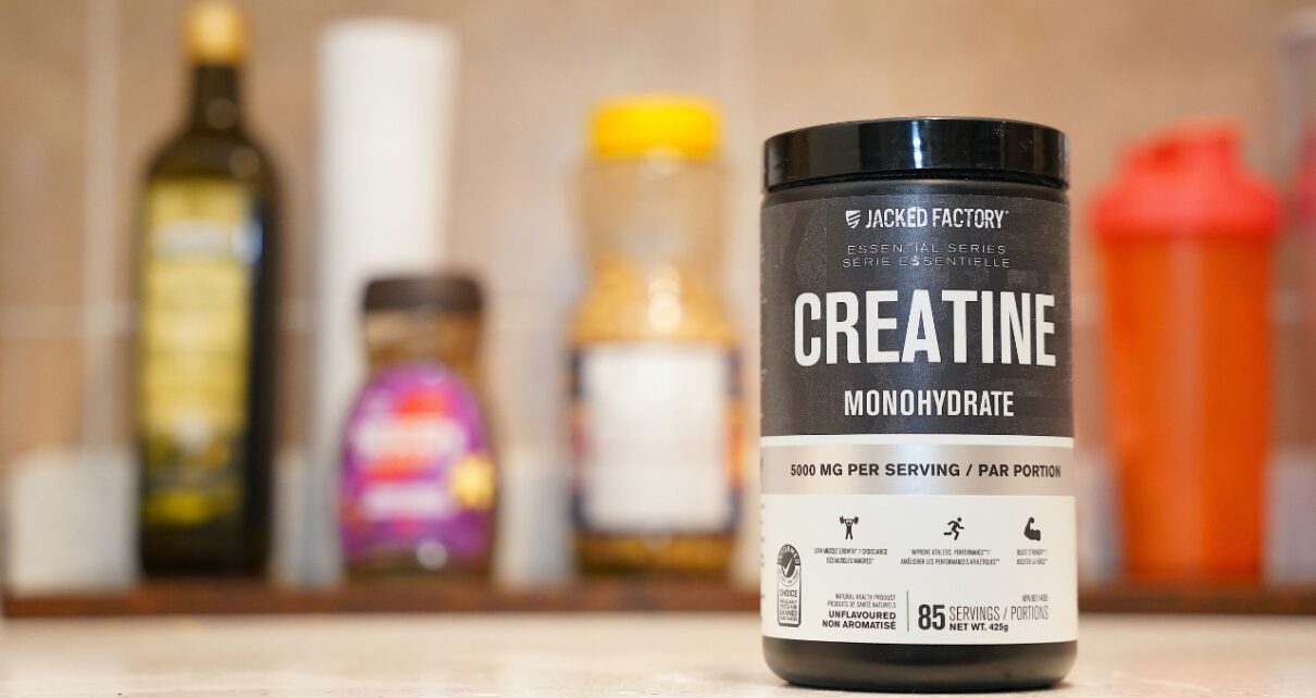 Container of creatine monohydrate on a kitchen counter.