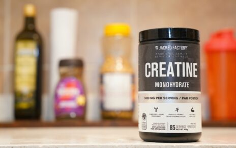 Container of creatine monohydrate on a kitchen counter.